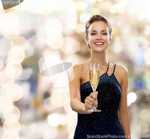 Image of smiling woman holding glass of sparkling wine