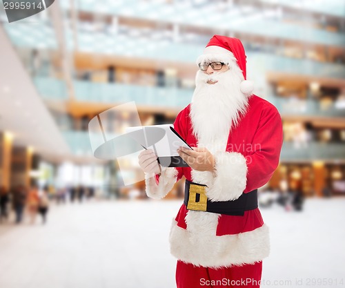 Image of man in costume of santa claus with notepad