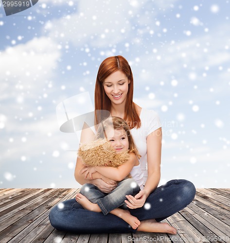 Image of happy mother with little girl and teddy bear