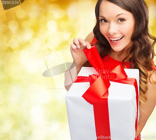 Image of smiling woman in red dress with gift box