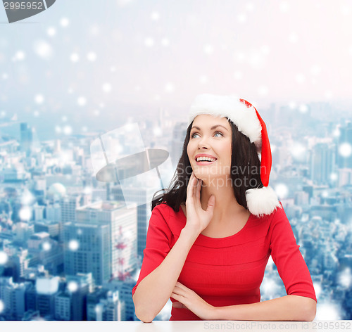 Image of smiling woman in santa helper hat