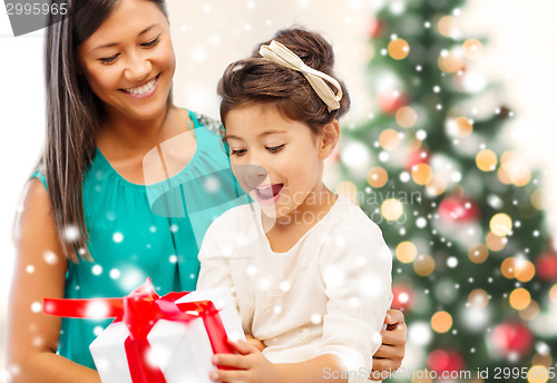 Image of happy mother and child girl with gift box