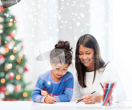 Image of mother and daughter with coloring pencils indoors