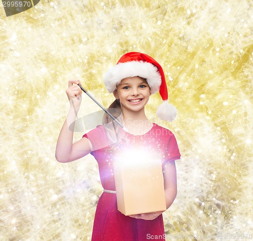 Image of smiling girl in santa helper hat with gift box
