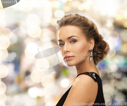 Image of beautiful woman in evening dress wearing earrings
