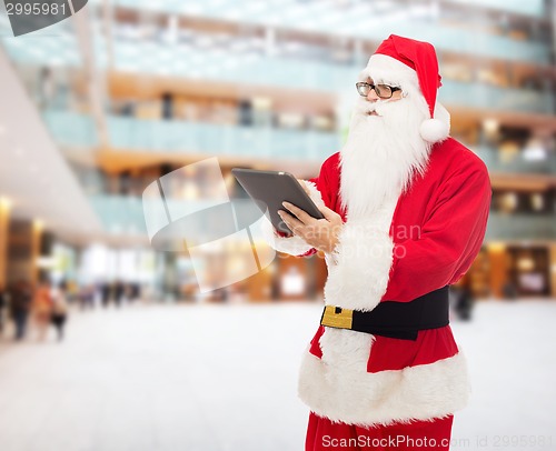 Image of man in costume of santa claus with tablet pc