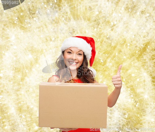 Image of smiling woman in santa helper hat with parcel box