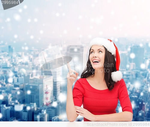 Image of smiling woman in santa helper hat