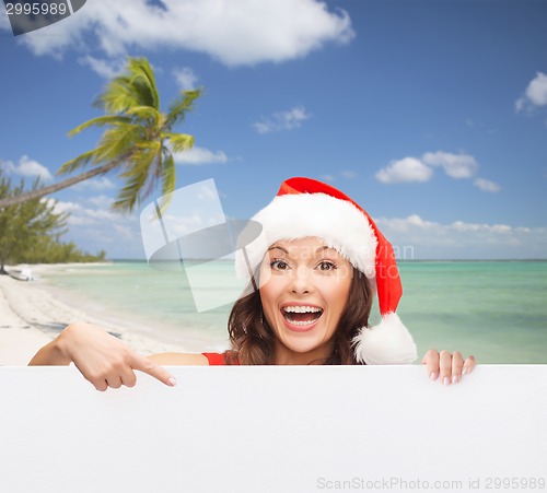 Image of woman in santa helper hat with blank white board