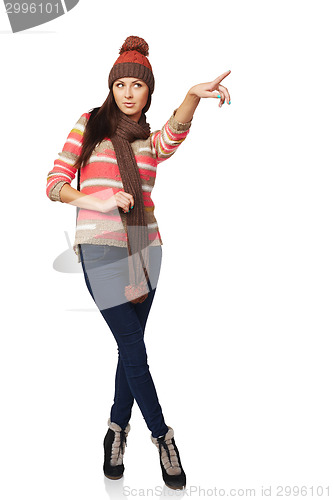 Image of Winter woman pointing at copy space