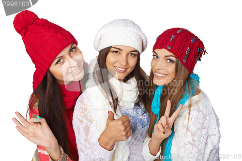 Image of Three girls showing approving gestures