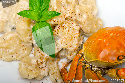 Image of Italian gnocchi with seafood sauce with crab and basil