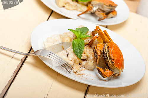 Image of Italian gnocchi with seafood sauce with crab and basil