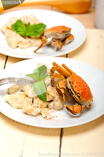 Image of Italian gnocchi with seafood sauce with crab and basil