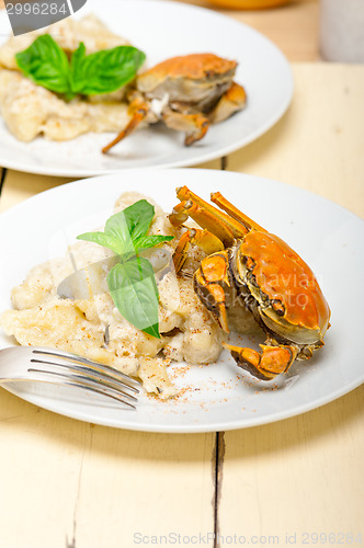 Image of Italian gnocchi with seafood sauce with crab and basil