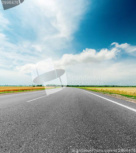 Image of black asphalt road and clouds in dramatic sky