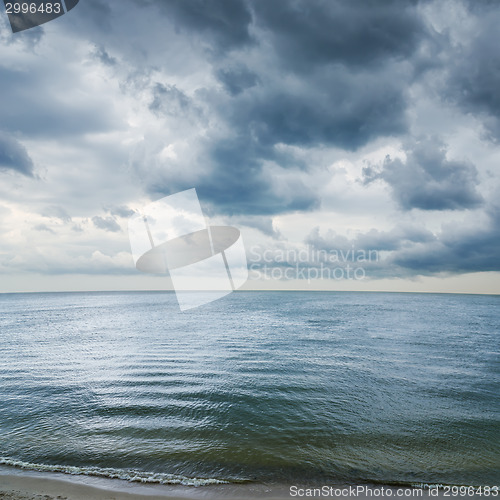 Image of low dramatic clouds over dark water