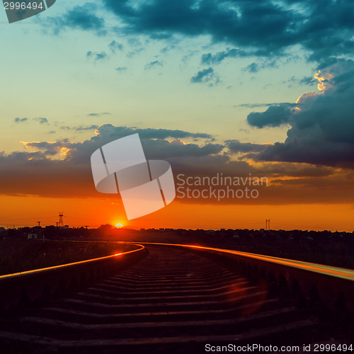 Image of low sun over railroad to horizon in sunset