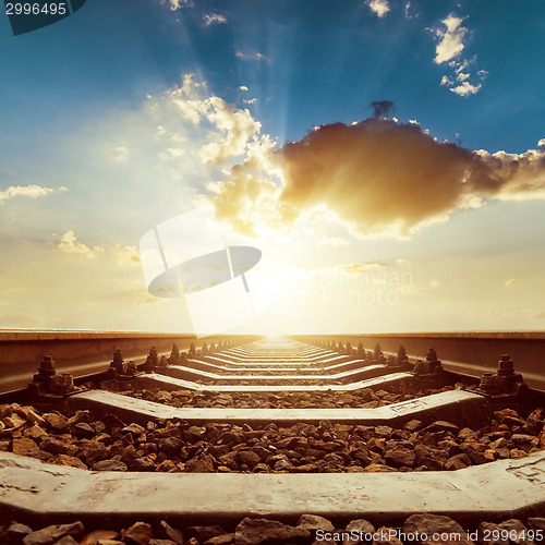 Image of sunset with clouds over railroad close up