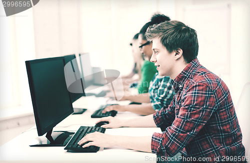 Image of student with computer studying at school