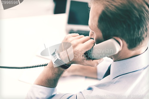 Image of handsome businessman talking on the phone