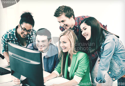 Image of students with computer studying at school