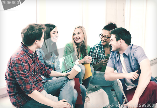 Image of students communicating and laughing at school