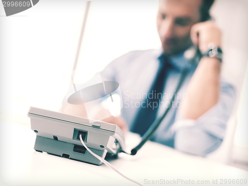 Image of handsome businessman talking on the phone