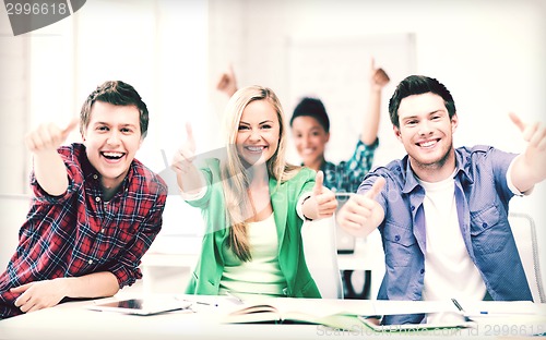 Image of students showing thumbs up at school