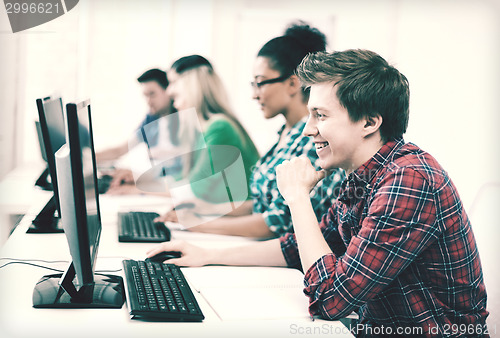 Image of student with computer studying at school