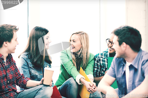 Image of students communicating and laughing at school