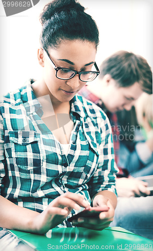 Image of student girl with smartphone at school