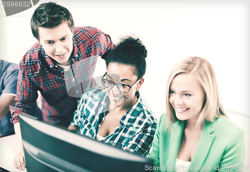 Image of students with computer studying at school