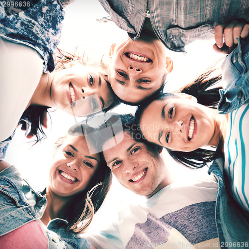 Image of group of teenagers looking down