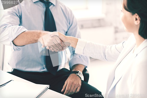 Image of business people shaking hands in office