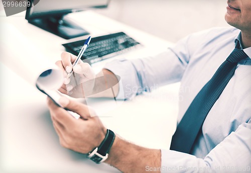 Image of businessman working and signing papers