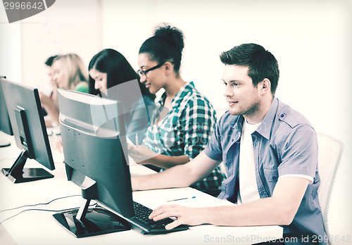 Image of student with computer studying at school