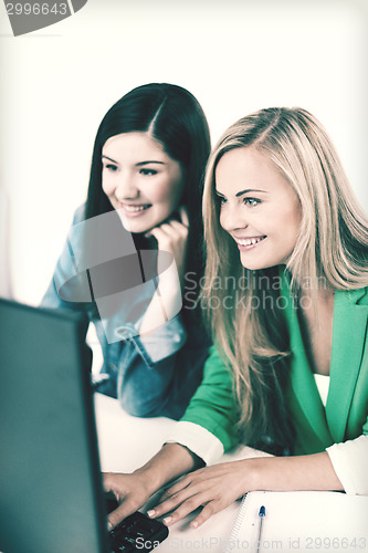 Image of students looking at tablet pc at school