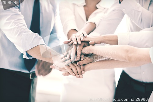 Image of business team celebrating victory in office