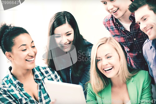 Image of students looking at tablet pc in lecture at school