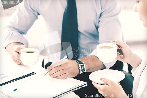 Image of man and woman discussing something in office