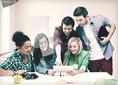 Image of students looking at tablet pc at school