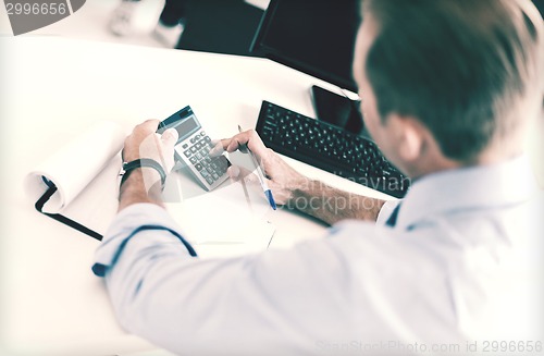 Image of businessman with notebook and calculator