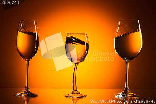 Image of three glasses on orange background