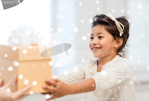 Image of smiling little girl with gift box