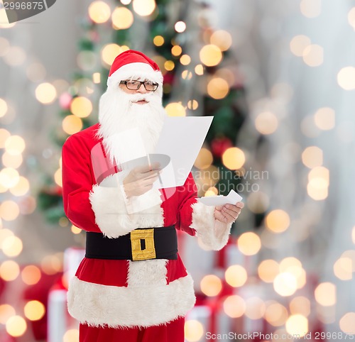 Image of man in costume of santa claus with letter