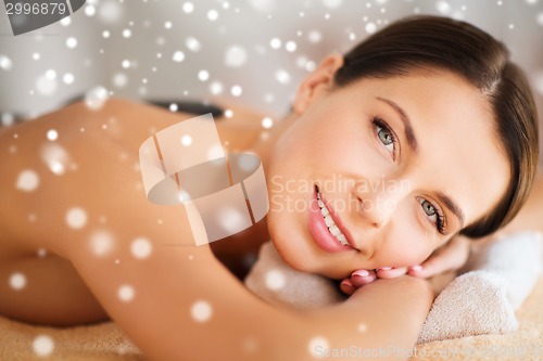 Image of woman in spa salon with hot stones