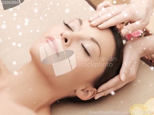 Image of beautiful woman getting face or head massage