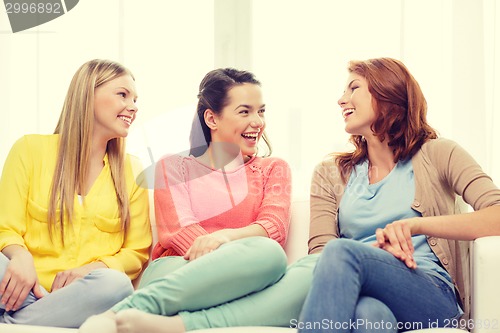 Image of three girlfriends having a talk at home