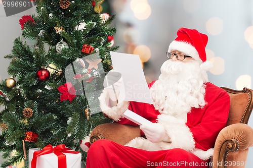 Image of man in costume of santa claus with letter